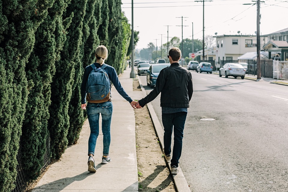 couple walking in sidewalk