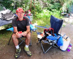 man sitting on a backpacking chair